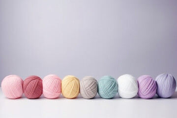 colorful pastel yarn on table with gray background - obrazy, fototapety, plakaty