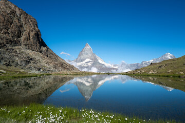 Naklejka na ściany i meble Switzerland travel - View of the Matterhorn from the Riffelsee early summer.