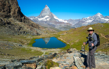 Senior man hiking the Swiss alps near the Matterhorn