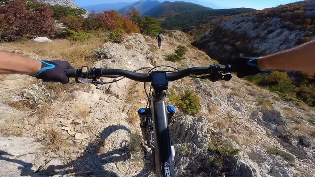 Group of friends Speed riding mountain bike downhill ride on a rocky path