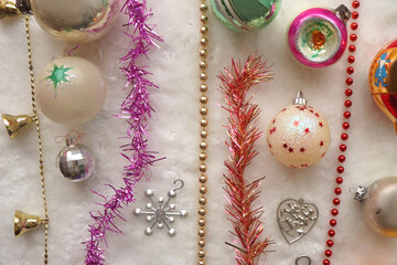 Colorful vintage Christmas ornaments and white faux fur blanket. Cute and kitschy Christmas decorations. Top view.