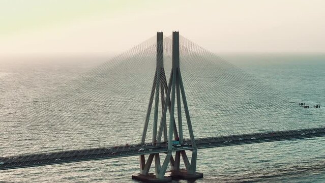 Cinematic aerial view of traffic passing over Bandra Worli Sea Link in Mumbai, India in the evening. Sunset View of the Sea Bridge. bridge over the sea.