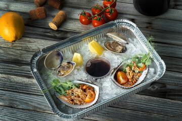 Raw uncooked clams shells shellfish with ingredients. A bottle of wine in the background and wine corks.