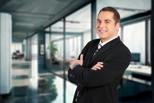 Smiling confident business man standing in office, AI generated image