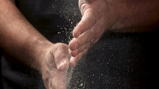 The cook's hands are covered in flour. Filmed on a high-speed camera at 1000 fps. High quality FullHD footage