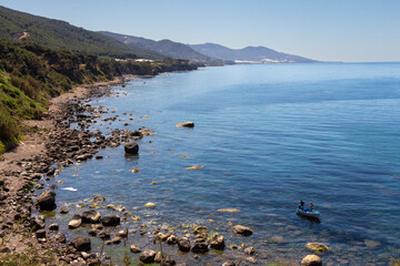 Algerian Mediterranéean coastline landscape between Cherchell and Damous, Algeria. Small boat with two Algerian people on the shore.