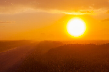 Foggy meadow at sunset