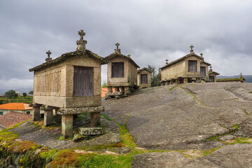 Fototapeta premium Granaries of Soajo or 'Espigueiros do Soajo' perched on stilts, on granite massif. They were built off the ground to protect food crops from rats and other rodents. Some are still used today. Portugal