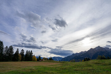 Fototapeta na wymiar Alpine landscape with summits and clouds in autumn
