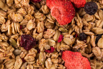 Muesli oat cereals close up background with dry fruits