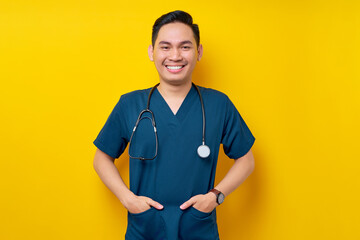 Professional young Asian man doctor or nurse wearing a blue uniform and stethoscope standing...