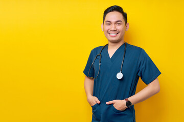 Professional young Asian man doctor or nurse wearing a blue uniform and stethoscope standing...