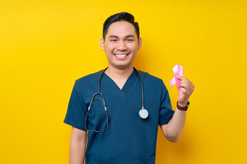 Smiling professional young Asian male doctor or nurse wearing a blue uniform and stethoscope...