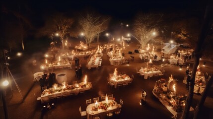 Aerial Shot of Winter Twilight Feast. Bonfire, Long Table Setting, Cooking Fire.