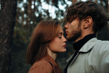 Fototapeta premium sensual couple in love close-up kissing, curly man and beautiful woman.