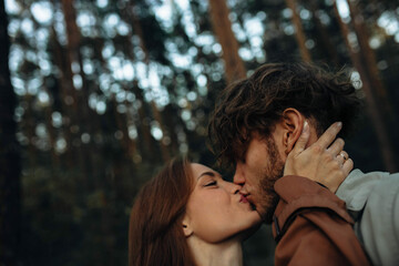 Fototapeta premium sensual couple in love close-up kissing, curly man and beautiful woman.