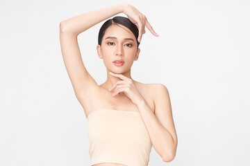 Beautiful Young Asian woman lifting hands up to show off clean and hygienic armpits or underarms on white background, Smooth armpit cleanliness and protection concept