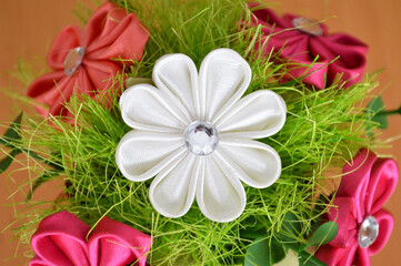 Handmade fabric flower. Hobby and craft concept. Artificial floral decoration.