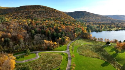 Fototapeta na wymiar Mountain, trees and fields in sunny landscape with campground and outdoor park in Autumn Fall Colors in Tioga, Pennsylvania Ives Run Campground