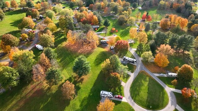 Campground with RVs and  people camping outdoors in mountains of Pennsylvania during Autumn Fall season at Ives Run in Tioga 