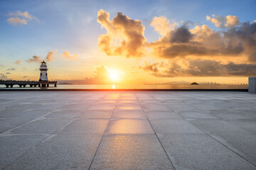 Empty square floor and lighthouse with coastline natural landscape at sunrise