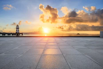 Poster Empty square floor and lighthouse with coastline natural landscape at sunrise © ABCDstock