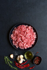 Homemade minced meat with spices. Top view with copy space.