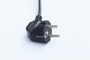 Black electric power cable with plug isolated on white background.