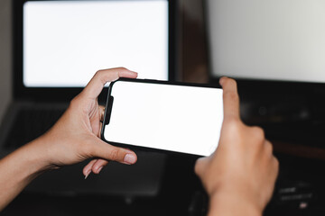 Mockup image of woman's hands holding black mobile phone with blank screen