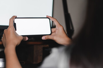 Mockup image of woman's hands holding black mobile phone with blank screen