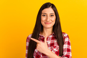Photo of charming young lady direct finger empty space cute smile look camera isolated yellow color background