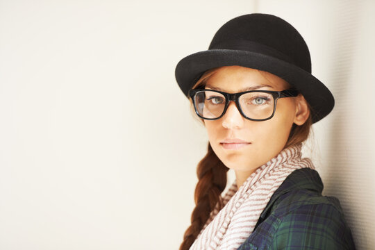Portrait, hat and serious woman in glasses for fashion in studio isolated on a white background mockup space. Face, eyewear and confident girl, model or young person in stylish clothes in Switzerland