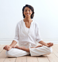 Woman, smile and meditate in lotus position at home, relax and peace or zen for mental health....
