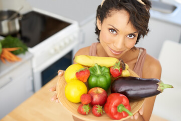 Portrait, health and vegetables with a woman in the kitchen of her home for nutrition, diet or meal preparation. Face, ingredients and a recipe for cooking food with a young person in her apartment