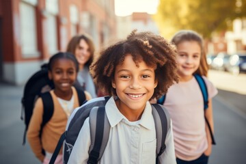 Group of cheerful schoolchildren hugging and looking at camera. Happy smiling multiethnic kids posing for group portrait. Children of different skin colors go to school together. Diversity concept.