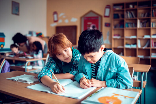 Two students collaborating on an assignment in the classroom