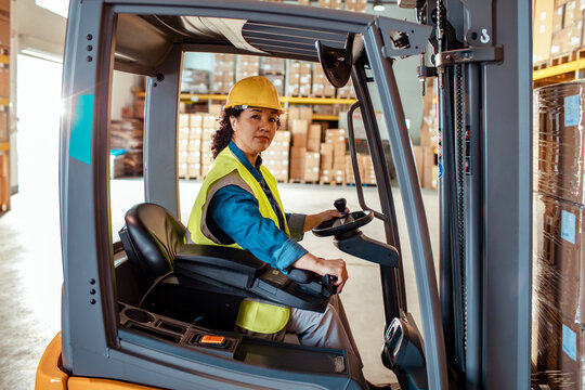 Portrait of a Focused Warehouse Worker Operating a Forklift