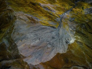 High angle shot of a rugged sandstone mountain surface, featuring rocky outcroppings