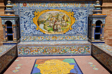 SEVILLE, SPAIN - 13 APRIL, 2023: The tiled Provincial Alcoves along the walls of the Plaza de...