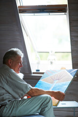 Man, artist or holding painting with pride in bedroom and happy elderly guy by window for creative...