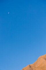 Crescent moon rising above a dramatic cliff gorge in Juta, Georgia
