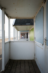 Shallow focus of English wooden beach huts in a popular Suffolk seaside town. Seen with beach huts...