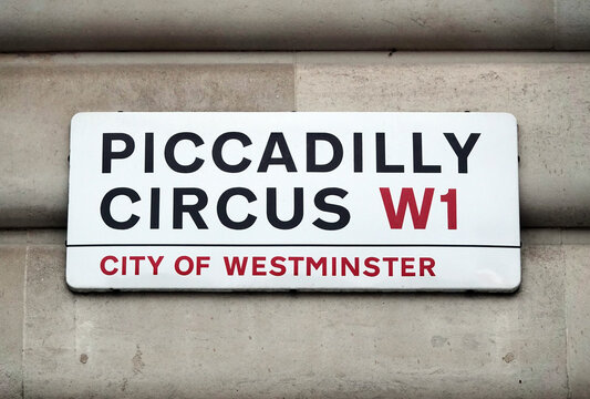 Piccadilly Circus sign on the wall of building in Westminster, London W1, England. 
