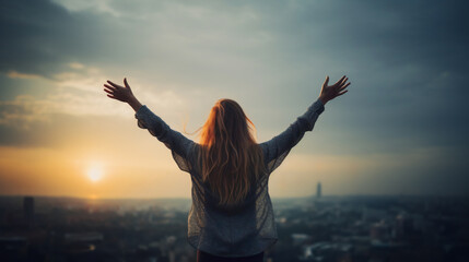 A young woman stands with outstretched arms, embracing the dawn as the sun rises over a vast cityscape. Concept of confidence and renewal, symbolizing hope, strength, determination, a new beginning