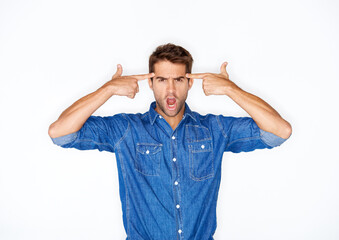 Portrait, fashion and finger gun with a crazy man in studio isolated on a white background for expression. Mental health, anger and a young model pointing to his temple to gesture a mind blown emoji