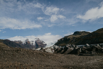 Woman standing next to the Svinafellsjokull glacier in Iceland