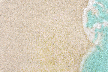 Background with emerald wave on white sand.