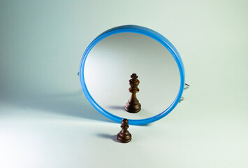 simple chess pawn who looks in the mirror and sees himself as king