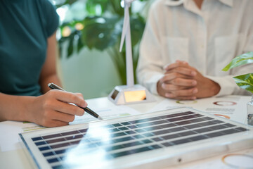 Solar panels green energy Business people working in green eco friendly office business meeting creative ideas for business eco friendly professional teaching corporate people sustainable electricity
