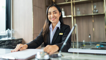 Beautiful asian hotel receptionist in  uniforms at desk in lobby Friendly and welcome staff in...